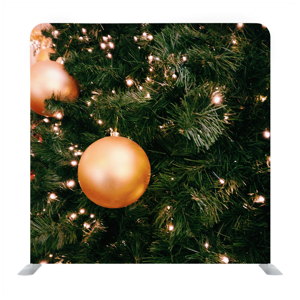 Bright Gold Balls On Christmas Tree Of Fir Or Spruce With String Rice Lights Bulbs Backdrop