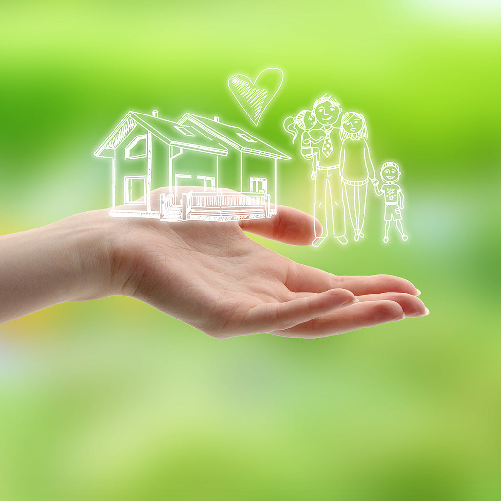 Female Hand with drawings of Family & House on Nature Background